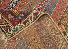 An exceptional Kurdish rug distinguished above all by its top-notch color and superb wool. The field is composed of lively diagonal bands, each carrying a different floral or geometric repeat and shifting through saturated brick red, deep indigo, grassy green, ivory, ochre, aubergine, and soft rose.