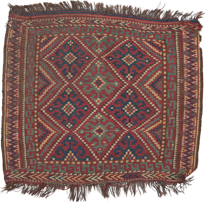 This small soumak was woven by Uzbeks in Northern Afghanistan during the 20th century.  This rug is tiny but vibrant and is composed of a colorful geometric design of interlocking diamonds that almost appear as two figures standing side by side. Framed by various borders of squares, 
