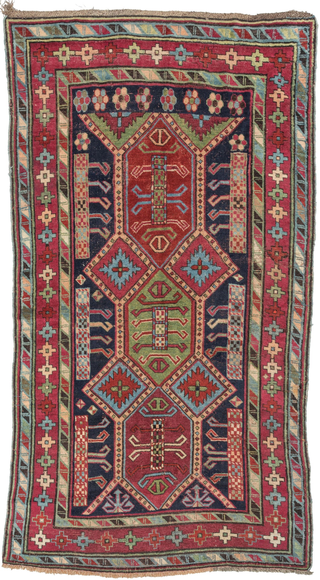 This rug was woven in the Karabagh region of the South Caucasus during the late 19th century.   Itt features a powerful all design of angular shapes on a deep navy ground. Framed by a main border of geometric plus shaped rosettes sandwiched between two 