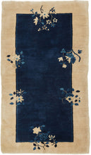 This Blue Chinese Deco Rug features an open blue field framed by a wide cream border. Two thin lines in navy and indigo separate the two color blocks and are straddled by various floral bouquets that provide the only decoration. Simple and straightforward with a luxurious feel.