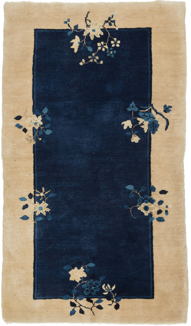 This Blue Chinese Deco Rug features an open blue field framed by a wide cream border. Two thin lines in navy and indigo separate the two color blocks and are straddled by various floral bouquets that provide the only decoration. Simple and straightforward with a luxurious feel.