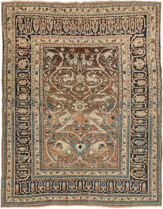 This Hadji Jalili Hunting Tabriz features a classic hunting motif against a backdrop of scrolling arabesques on a desirable burnt orange ground that is highly characteristic of Hadji Jalili weaving. The arabesque grows from central palmettes sprouting leaves and floral forms while providing a lush landscape for various animals to frolic. The animals are rendered in pairs with the most prominent showcasing lions hunting deer near the bottom.