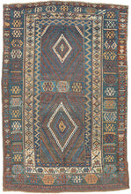 This rug was likely woven likely in the Hakkari - Rawanduz corridor of the Kurdish Highlands of Iraq during the turn of the 20th century

This deeply expressive Kurdish village rug presents a masterclass in tribal geometry, color harmony, and cultural symbolism. It features a field anchored by two nested diamond medallions, each filled with small, rhythmic glyph-like motifs and set against a ground of saturated indigo blue and madder red abrashed into glowing mineral shades. Surrounding the central field ar