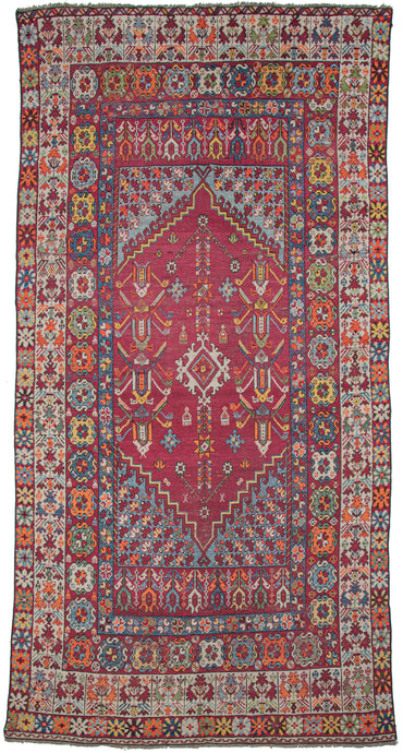 Moroccan Rabat Kelleghi colorful rug featuring an ornate and colorful design inspired more by the Ottoman aesthetics than the indigenous Amazigh tradition. It is woven in bright reds, blues, yellows, greens, and oranges. 