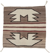 This&nbsp;Navajo rug was handwoven in the southwest United States during the 2nd quarter of the 20th century.

A beautifully balanced small-format Navajo weaving, showcasing bold symmetrical motifs rendered in a ground of hand-spun, natural wool tones. Graphic stepped&nbsp;forms float against soft variegated browns, mirror one another on each side of a classic banded center that is accentuated by&nbsp;warm red accents.