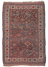 Antique Qashqai Shekarlu rug featuring a spectacular all-over field chock full of latch hooked polygons, rosettes, serrated combs, and various types of animals and protection symbols. Beautifully layered with haphazard spontaneity and free-flowing shifts in scale and rhythm yet still cohesive and engaging like well-improvised Jazz. It features captivating reds, soft blues, yellows, purplish-brown and bright ivory on a rare greenish-blue ground.