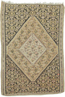 This Senneh kilim was woven by Kurds during the second quarter of the 20th century.   This finely woven kilim features a double diamond medallion on a classic herati design ground in black, yellow, caramel, coral, soft purple and slate. Framed by a simple interlocking jigsaw border.