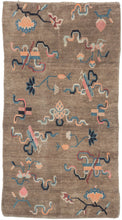 This Khaden was handwoven in Tibet during the early 20th century.   It features an open field of various whimsical cloudbands and other abstracted shapes and floral motifs. A wonderful palette of maroon, pink, orange, indigo and sky blue floats above the camel ground. The format and design suggest use as a "Khaden" or sitting rug usually associated with Tibetan weaving.
