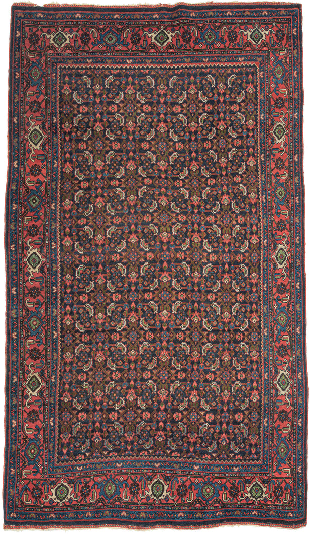 This Bidjar was handwoven during the second quarter of the 20th century.

It features an all-over herati patterned field in blues, reds, coral, ivory and green on a midnight blue backdrop. This bidjar lives up to its reputation as the 