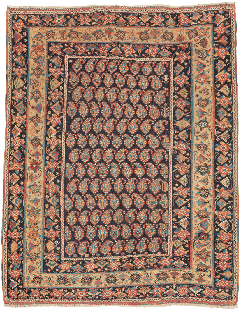 A beautifully composed Afshar rug featuring a classic allover boteh field, each sprouting motif rendered with crisp definition against a deep indigo (almost black) ground. The botehs are arranged in tightly organized rows, creating a shimmering, textile-within-textile effect that rewards close looking. Subtle shifts in dye tone animate the surface, giving the field a sense of depth and movement.

Framing the boteh lattice is a vibrant, floral border system of spiraling blossoms, stylized palmettes, and angu
