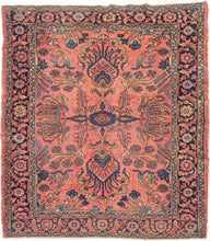 This classic Lilihan rug features a graphic medallion in navy, turquoise, red, and gold on a peach-pink ground. The all-encompassing medallion is composed of ornate curvilinear floral sprays and is freely spaced. Framed by a meandering palmette border with a midnight ground.
