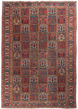 Mid century Bakhtiari Garden rug featuring a classic garden design in madder reds, indigo blues, and soft yellows, browns, and ivories. A shrub, flower or tree appears in each square with an alternating repeating pattern. The reconciled main border showcases blue and salmon palmettes and serrated leaves on an ivory ground.