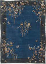 This Deco rug was handwoven in Eastern China during the second quarter of the 20th century.  It features an open indigo field framed by a wide navy border. Flowering vases and branches that start in the border grow freely into the field unrestrained. A flower filled vase with a bird perched on one of its branches can be found near the center of the composition. Various birds and butterflies can also be seen frolicking amongst the flowers