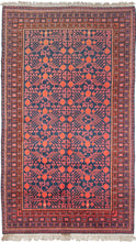 This Khotan rug was woven in Northwest China, which is also known as East Turkestan, during the second quarter of the 20th century.   This rug features an all over design of interconnected vines with blossoming red and purple pomegranates on a navy ground.  Framed by multiple thin borders with latchhooked devices. Nice fluffy full pile.