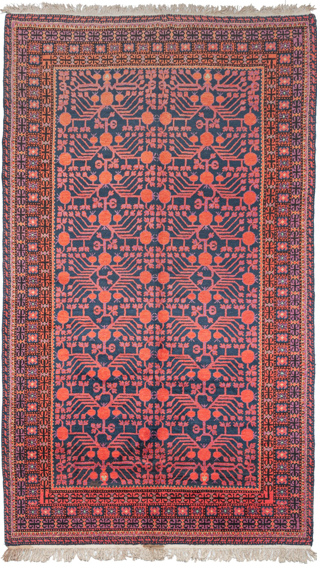 This Khotan rug was woven in Northwest China, which is also known as East Turkestan, during the second quarter of the 20th century.   This rug features an all over design of interconnected vines with blossoming red and purple pomegranates on a navy ground.  Framed by multiple thin borders with latchhooked devices. Nice fluffy full pile.