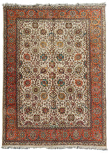 Tabriz room rize rug featuring multiple interconnected palmettes in teal, light sage and an array of autumnal tones like orange, yellow and brown on an ivory ground. The main border is composed of alternating palmettes on a orange ground. The orange used throughout the composition is quite prominent and brings to mind fall foliage and pumpkins.