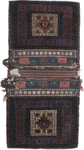This double saddlebag or "Khorjin" was woven by the Baluch near the border of Iran and Afghanistan during the second quarter of the 20th century.  The bag face is pile woven with a flat-woven back. Each side features a stepped polygon central motif contained in a camel square surrounded by dark red and blue borders.