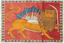 This Gabbeh rug was handwoven during the 20th century.  It features is a lion holding a saber in front of the sun which the classic national symbol. Following the revolution, this symbol was replaced on the national flag. Here the lion is rendered in orange with a full mane against a red background which has faded through 2/3 of the rug leaving the remaining third more saturated. A mohawk top white sun peeks over it's back. 