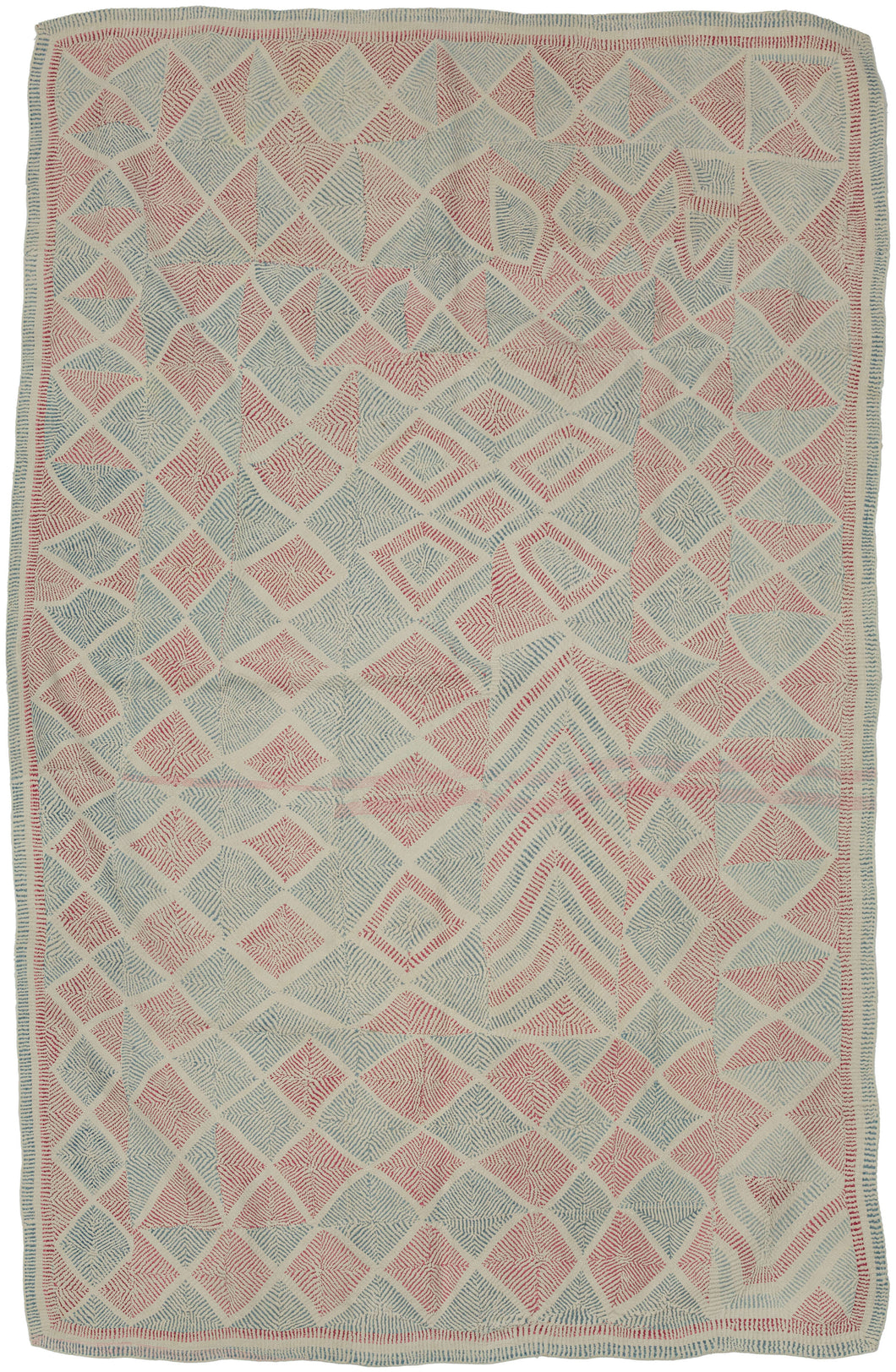 A striking Lahori kantha from the Rajshahi region of Bangladesh, densely worked in running stitch to create an all-over field of shifting diamonds, triangles, chevrons and pinwheel-like forms. The name Lahori or Lohori is generally associated with lahari or lehar, meaning “wave,” a reference to the rhythmic, undulating effect created by its densely repeated geometric stitching rather than to the city of Lahore.