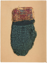 This Pre-Columbian textile fragment dates to the Wari period (circa 600–1000 AD) and is believed to be a panel from an elite tunic, serving as a form of rank insignia.

The design features a bold, labyrinthine geometric motif in tone on tone indigo and turqoise offset by remnants of a multicolor section in cochineal red, gold, and turquoise. These complex patterns are emblematic of Wari statecraft, where textiles conveyed status, authority, and identity.&nbsp;Technically, this piece exemplifies the Wari mas
