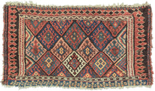 This bag face was woven by the Jaff Kurds of the Northern and Central Zagros mountains in Wester Iran during the late 19th century.  It features the classic Jaff interlocking diamond pattern in bright, cheerful colors. It is framed on three sides by a fun and wonky laleh abbasi border in black and red that becomes black triangles on a red ground before shifting back to laleh abbasi but with the colors reversed. The fourth side features red and white circles on an indigo ground. 