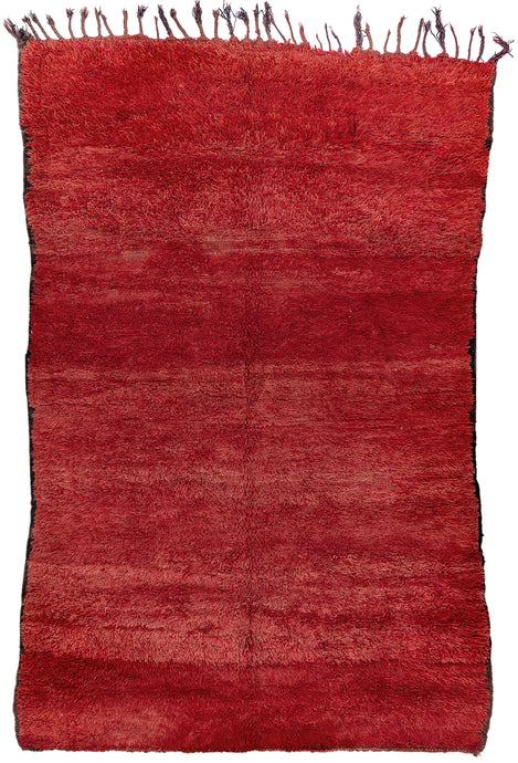 This Beni Ourain rug was woven in the Middle Atlas mountains during the 20th century.  It features a dramatic red colored ground that appears solid at first glance but with very nuanced shifts in tone. The end selvedges are finished in black adding contrast and subtle framing. A simple yet fantastic piece.