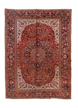 A bold and characterful Heriz carpet with a classic architectural composition anchored by a powerful central medallion. Angular vinery and serrated leaf forms radiate outward across a richly saturated madder-red field, surrounded by dynamic drawing that balances tribal energy with the structured geometry typical of the Heriz weaving tradition.