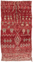 This Beni rug was woven in the middle Atlas mountains of Morocco during the 20th century.  It features abstracted vegetal and zoomorphic shapes in soft green and pink on a red ground. A very free spirited weaving.