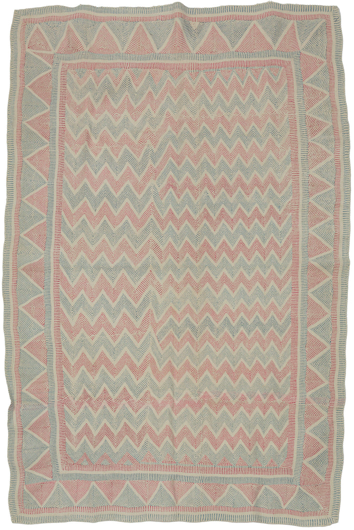 A finely worked Lahori kantha from the Rajshahi region of Bangladesh, densely embroidered in running stitch with alternating bands of faded red and soft blue. The name Lahori or Lohori is generally associated with lahar or lehar, meaning “wave,” a fitting description for the rhythmic movement created by its repeated geometric stitching.