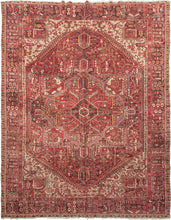 This Heriz rug was handwoven during the mid to late 20th century.  This classically designed Heriz features a geometric central medallion on a dark red field with complementary light and dark blues, yellow, pink camels and ivory. A border of alternating floral spray main border frames the prominent central medallion and four ivory ground cornices. A durable rug in a large room size that is great for high-traffic areas.