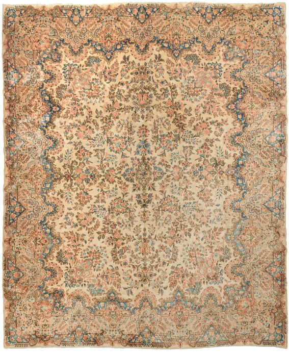 This Pastel Kerman Rug an elegant allover design of floral sprays in pastel pinks, reds, blues, browns, and gold and on a sandy khaki ground. It is framed by a wide border in the same tones of various bouquets that enter the field along its scalloped edges.