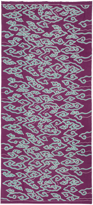 This vintage batik textile is showcases the classic mega mendung or cloud motif with graphic flair and vivid contrast. Floating across a rich purple ground, the swirling turquoise cloud forms evoke movement and energy, like wind-drawn currents or rising mist. The stylized clouds—long associated with spiritual transcendence and protection in Javanese design—feel newly alive in this modern palette.

The batik technique here is cap (stamped) or possibly hand-drawn tulis with a freeform flow, lending the d
