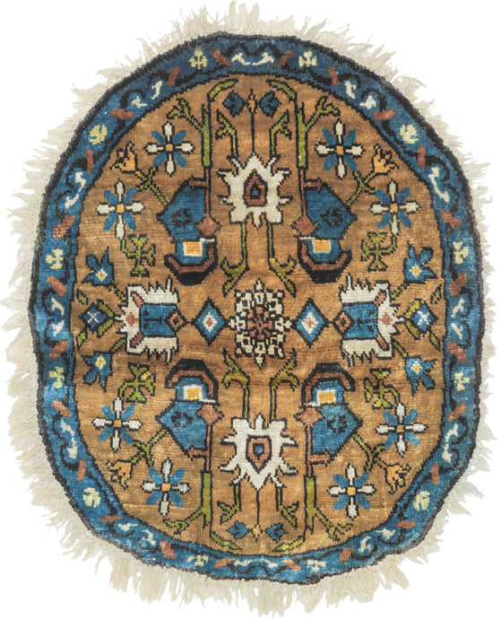 This Midcentury Chinese Silk Oval Rug features a central design reminiscent of the classic herati with curling tendrils and blossoming buds. In a nice oval format with tones of copper, cobalt, green and cool ivory.