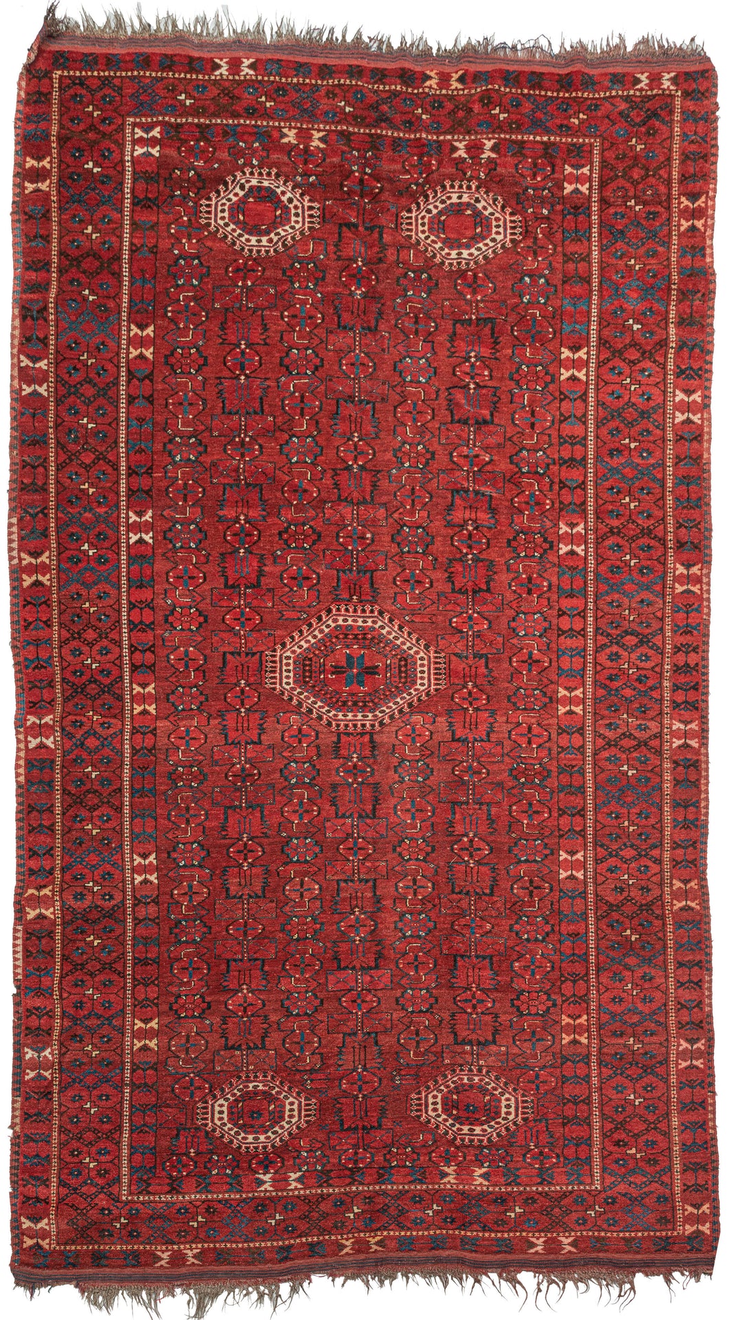 Beshir Turkmen rug handwoven along the Amu Darya river in Central Asia.  It features one large central medallion and four smaller medallions on the top and bottom of this wide and narrow format which is common for type. The medallions sit at an all over design of an abstracted herati variation with wide leaves, rounded rosettes and arrow like forms. various borders of tulips, evil eyes and eight pointed rosettes. 