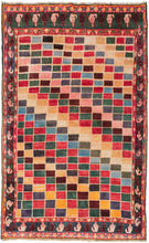 This Gabbeh rug was handwoven in Southern Iran during the middle of the 20th century.  It features alternating stepped rows of polychrome squares that travel on the diagonal creating a geometric rainbow effect. With a main border of light and dark boteh on a wonderful green ground framed by minor borders of alternating "u"s on a vibrant red ground.