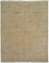 This Tibetan rug was woven during the late 20th century by Tibetan weavers in the Kathmandu Valley of Nepal for the Tufenkian Studio.

It is rendered in a tranquil tone-on-tone palette of warm golds, beiges, and soft dusty pink. The the rug features a subtle relief pattern of leafy vines and gentle wave motifs that are achieved through masterful carving and pile manipulation.The composition strikes a quiet harmony between texture and tone, allowing natural light to animate the surface with understated elega