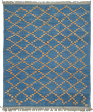This Moroccan-styled rug was woven during the 21st century in Afghanistan.  It features a simple diamond lattice pattern comprised of speckled gold squares on a cobalt ground. The lattice is consistent but with some subtle nuance in it's rhythm and casually breaks apart near the top and bottom of the rendering. Woven of hearty, hand-spun Afghan wool giving it durability and extra heft not commonly found in the Moroccan weaving usually associated with this patterning. 