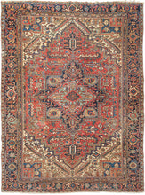 This ﻿Heriz rug was handwoven in Northwest Iran during the second quarter of the 20th century.  This classic Heriz features a geometric central medallion on a madder red ground. The four cornices loosely mirror the field design in a different color combination with the use of ivory working to light the composition. The inclusion of marled yarn palmettes  and "distinguished" serrated leaves add interest and give the piece a distinct feel. The main border is composed of an intricate palmette design 