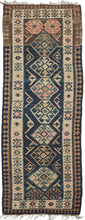 NW Persian kelleghi kilim runner featuring a stunning indigo blue field, with a bold geometric design of medallions and line shapes. Soft browns, ivories and watermelon complete the color palette.