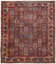 Bakhtiari oversized garden rug featuring a grand rendition of the classic garden design in rich reds, blues, gold, green, pink and ivory. Shrubs, palmettes, botehs, flowering branches, and various trees appear in each square with an alternating repeating pattern. The reconciled main border showcases large palmettes and serrated leaves on a bright ivory ground which lightens the composition. 