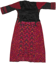 A bold and finely worked Palestinian thobe from the Ramallah–al-Bireh region, distinguished by its saturated red embroidery set against a dark ground and its highly structured, architectural composition.

Dense geometric embroidery covers the skirt, sleeves, and shoulders in tightly organized grids of stepped squares, lozenges, and subdivided diamonds. Vertical embroidered panels frame the body, while the chest features a strong triangular yoke above three square motifs, a characteristic layout associated w