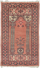It features a flowering vase flanked by two pillars below a hanging lantern in soft pinks, red, navy and ivory. Woven in Pakistan by Afghan refugees in the 1980s, the pattern is a classic prayer design which is unusual for type as these often feature more traditional Turkmen derived patterns.
