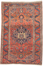 vintage bakhtiari. It features a navy central medallion on patinated red ground. The main border is in the same red and filled with serpentine leaves that swirl like bent ribbons. The blues and reds showcase a spectacular abrash or natural dye variation that give this piece fantastic movement.