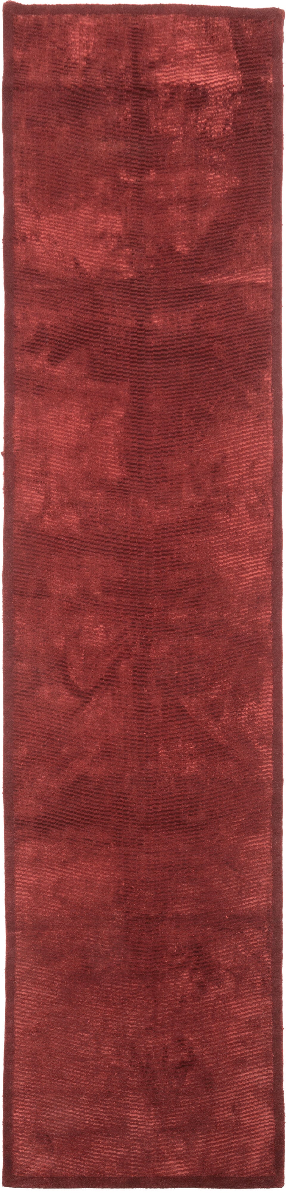 Silk and wool Tibetan orangey red runner was beautifully woven in a shade of deep and brilliant red. The wavy undulating pattern comes through thanks to the contrast between the wool and silk, the play of light and dark emphasized by the light. 