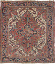 This Serrated Leaves Heriz Rug features a geometric central medallion on a rich red ground. Surrounded by a field of bright ivory and four trident cornices. Large and "distinguished" serrated leaves found on the ivory ground and in the cornices add distinction. The main border is composed of an alternating palmette design.