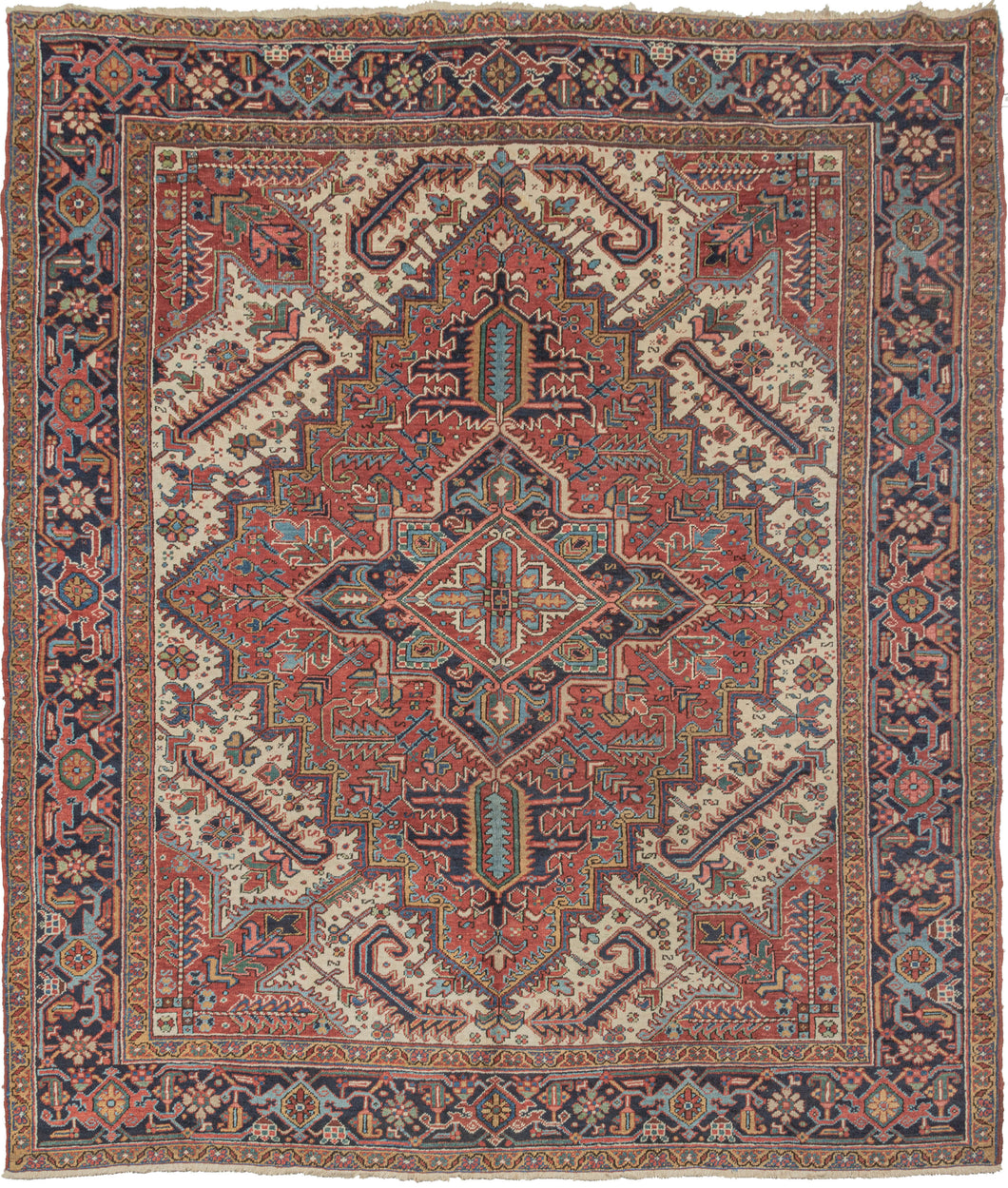 This Serrated Leaves Heriz Rug features a geometric central medallion on a rich red ground. Surrounded by a field of bright ivory and four trident cornices. Large and 