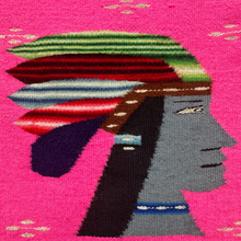 A bold mid–20th century Zapotec pictorial weaving from Oaxaca, Mexico, featuring the profile of a stylized figure in vivid detail. The face, woven in slate grey, is framed by long black hair and a richly patterned striped headdress in green, red, and blue, accented with white. The figure wears a beaded blue necklace, adding further ornament.

