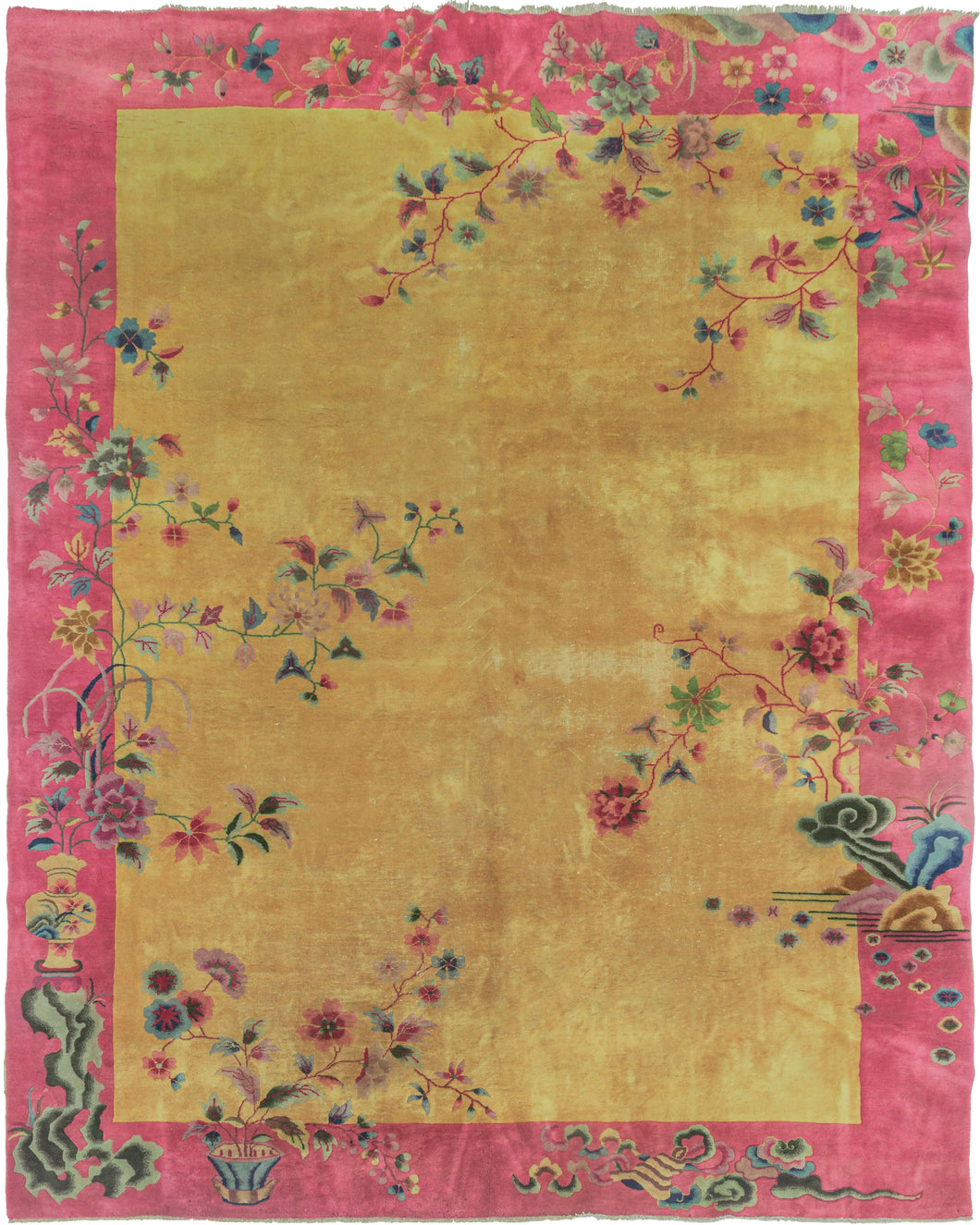 Vibrant golden antique Chinese Deco rug with a pink border and a rainbow of flowers, vases and textural rocks finely knotted into the design