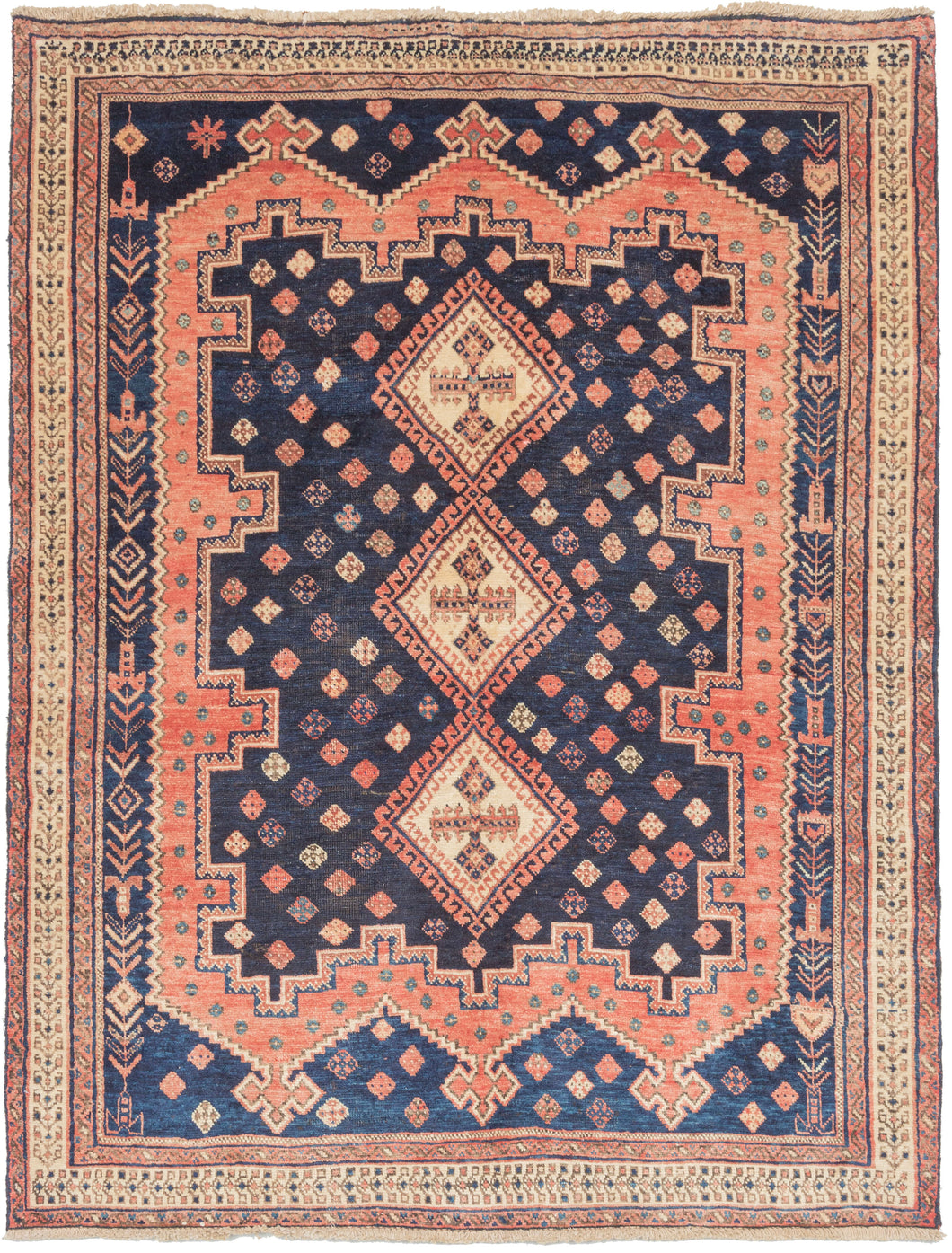 This Afshar rug was woven during the end of the 20th century.  It features classic patterning associated with the Afshar people of Sirjan. In the center are three small ivory medallions on a deep navy field surrounded by a glowing pink field which itself lays upon a final field of cobalt. The classic palette of reds and blues is rendered in a softer more pastel variant here. Small symbols and figures fill the negative space, making this a very visually interesting rug.