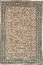 This Kayseri rug was handwoven in Central Turkey during the middle of the 20th century.  It features an elegant allover design of rosettes entangled in waves of scrolling vinework sprays in greens, purples, blues, black, and pink on a sandy ground. wonderful seafoam green ground. The intricate spiraling floral sits on an exceptional green ground that shifts from emerald to jade and may be the best attribute of a very nice rug.